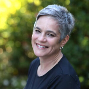 A woman with short hair is smiling for the camera.